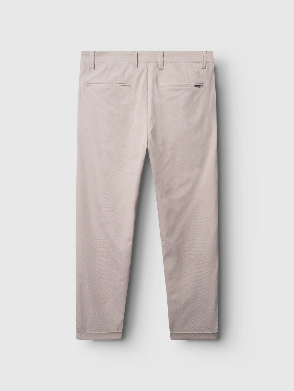 The Gabba Pisa K3280 Dale Pants in Grey Paloma, displayed from the back against a light gray background, feature high-stretch fabric with belt loops, two back pockets, and a small brand label near the waistband. The cuffs are neatly folded.