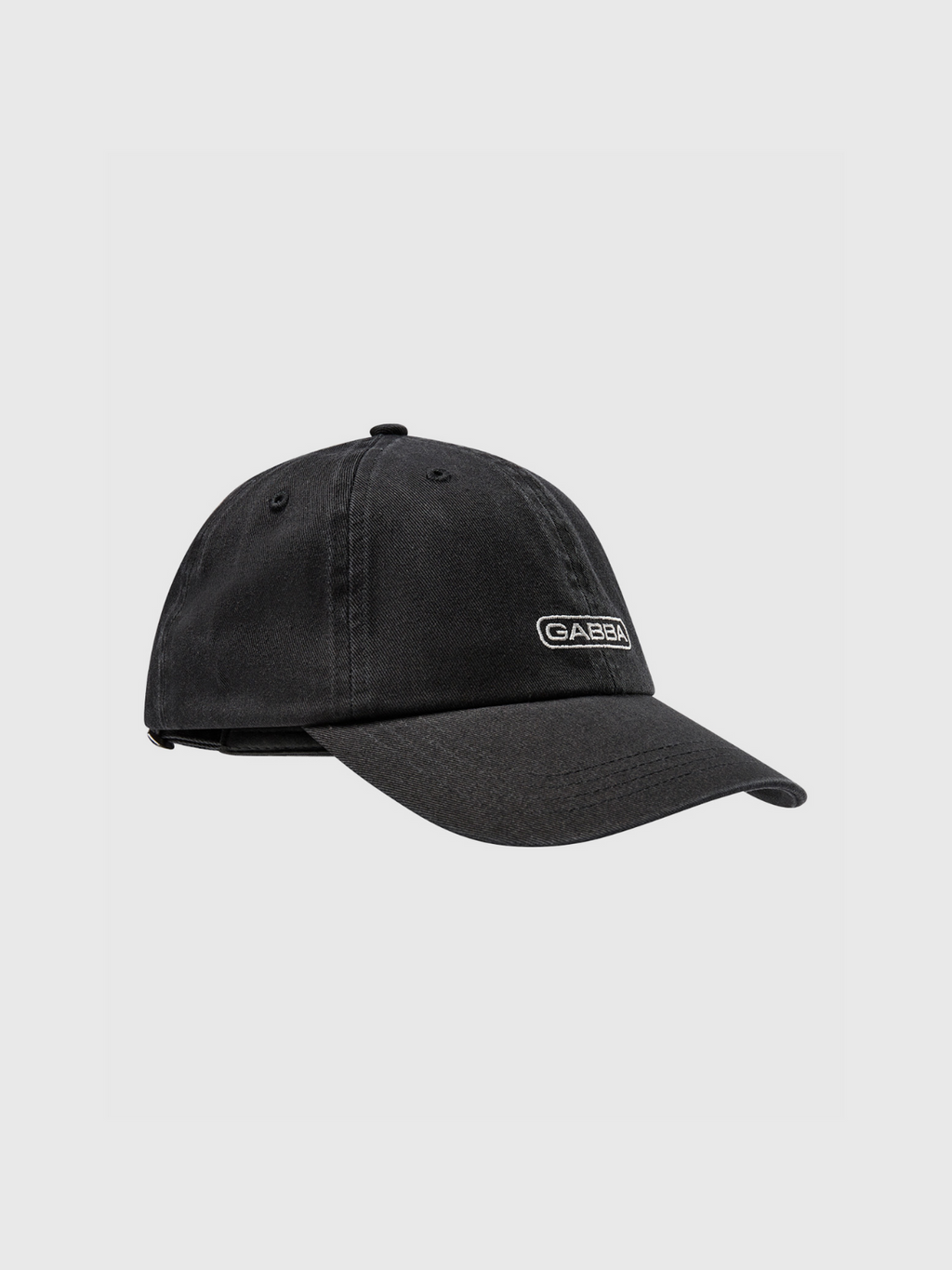 The Gabba Cap - Black by Gabba is a stylish baseball hat featuring a classic design, comfortable fit, curved brim, adjustable strap, and a small rectangular Gabba patch on the front. Set against a plain light gray background.