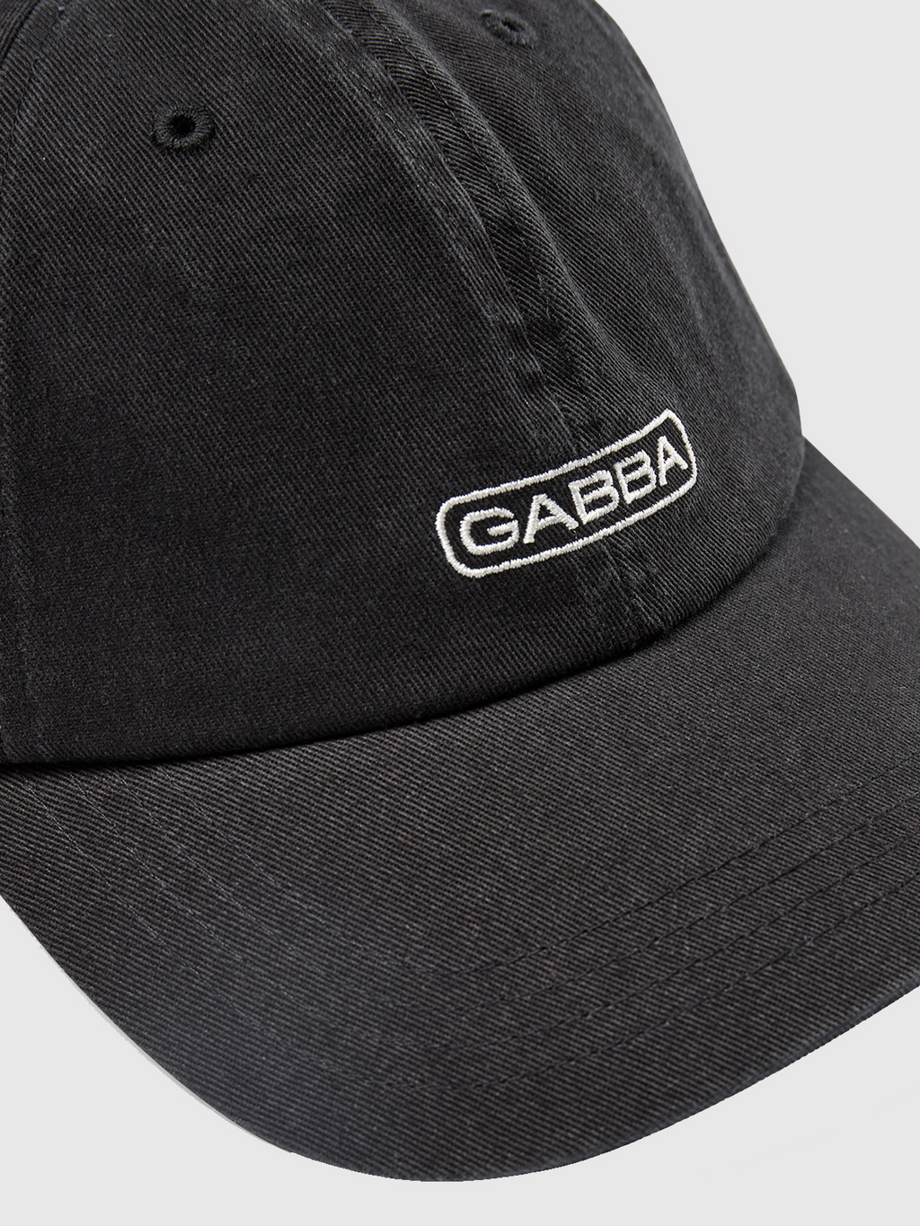 Gabba Cap - Black features GABBA embroidered in white, with textured fabric for style and comfort. Its classic design includes a standard curved brim on a plain, light background.