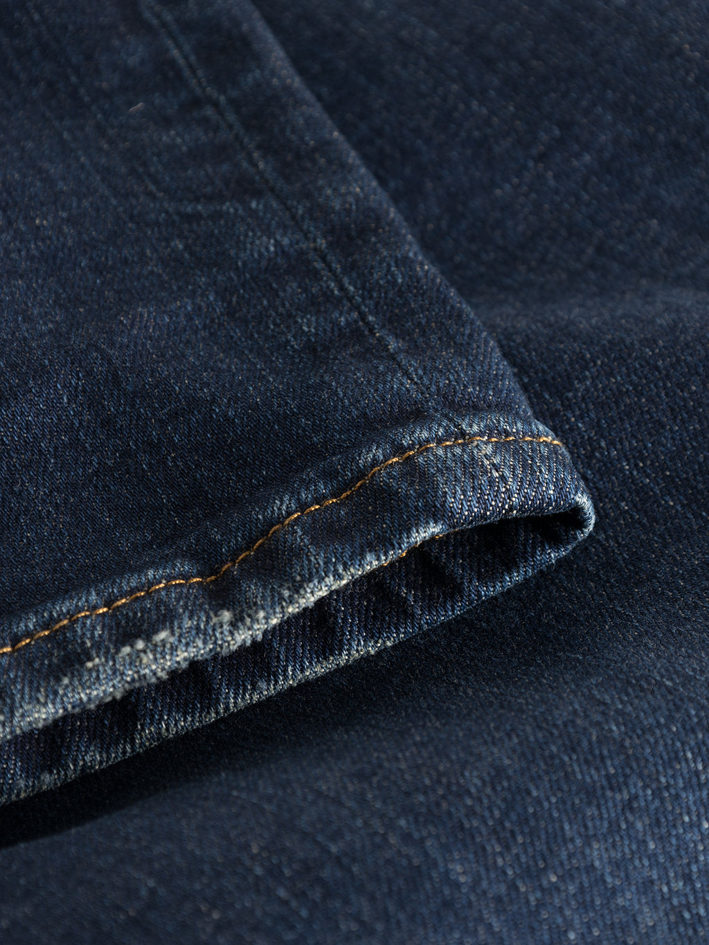 Close-up of Rey K4441 - Mid Blue Denim by Gabba reveals its timeless charm with visible contrast stitching and classic jeans weave, highlighting slight color variations for a laid-back look.