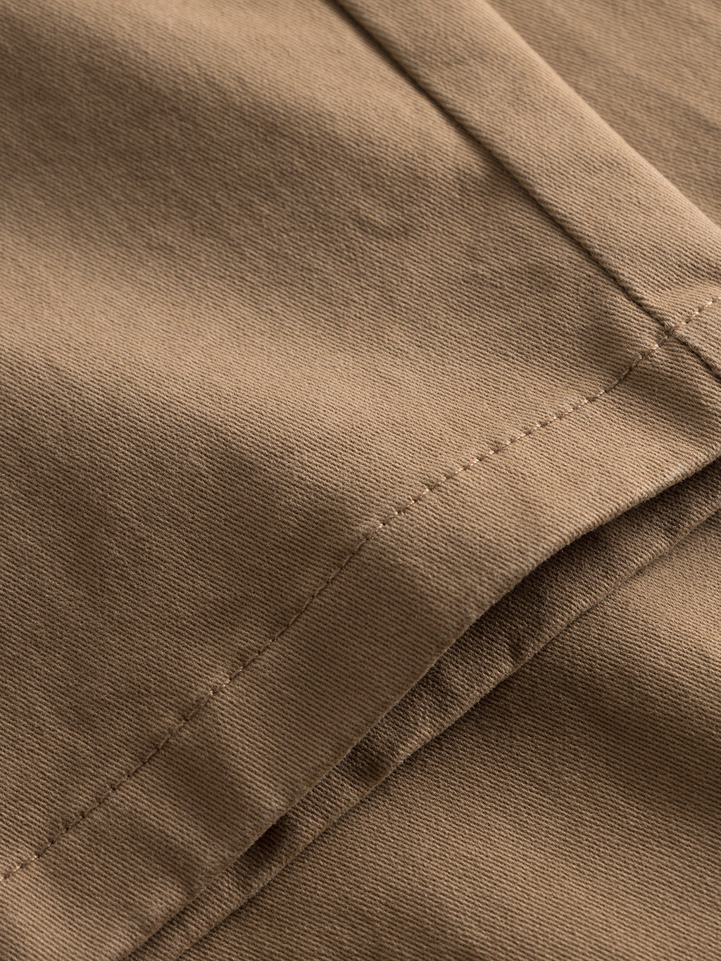 Close-up of the Venza Chino - Lt. Brown by Gabba shows smooth, finely woven fabric with detailed stitching and a folded edge, akin to a classic chino, making it essential for any mens wardrobe.