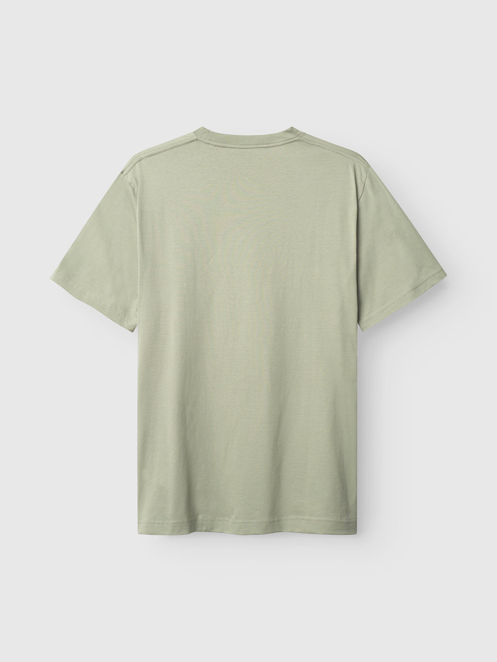 A plain Dune Logo SS GOTS T-shirt by Gabba is laid flat, showing its back. The light green, organic cotton shirt features short sleeves and a simple design against a light gray background.