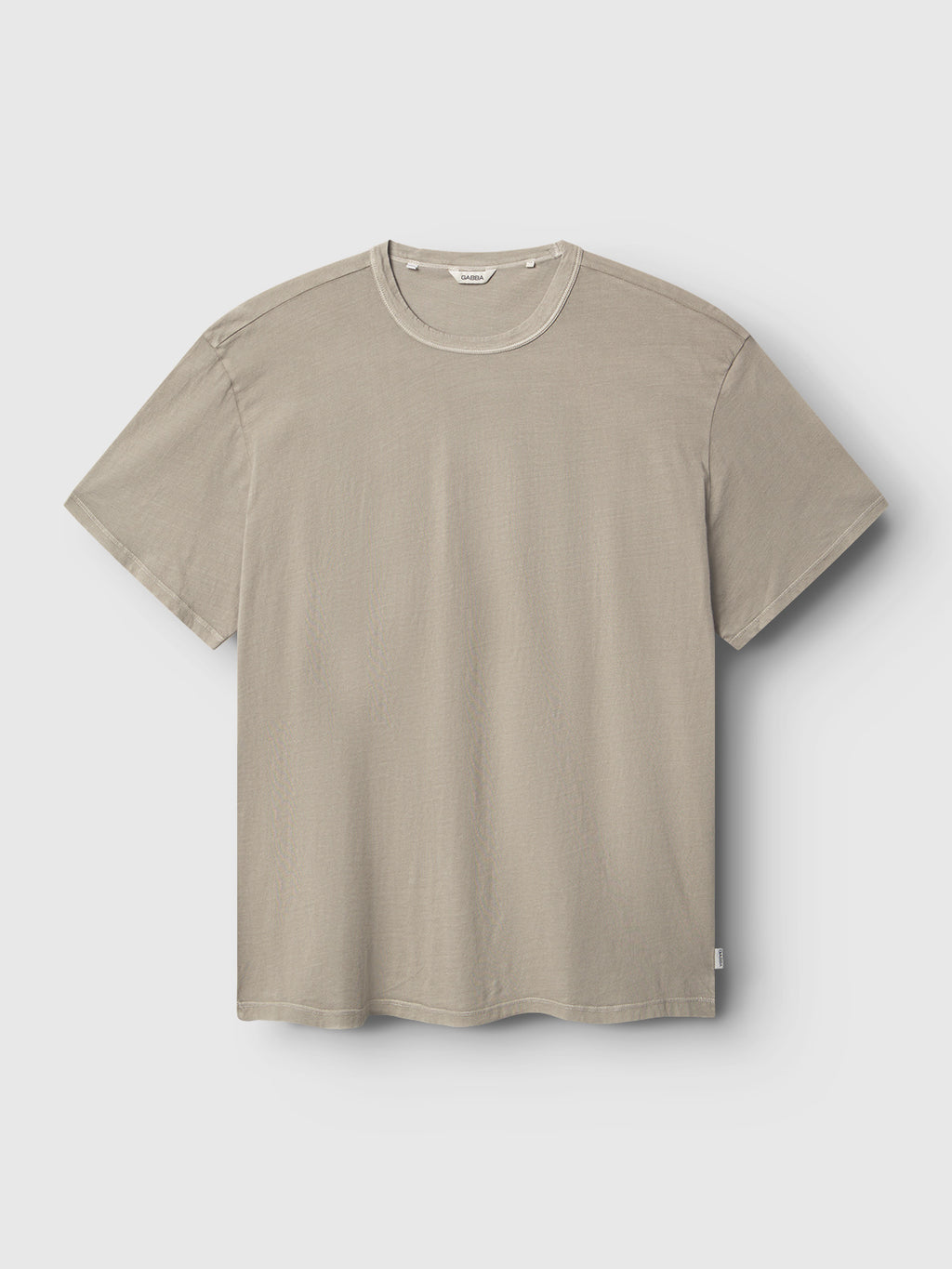The Gabba Lagos SS - Grey Paloma is a short-sleeve crew neck t-shirt in soft grey, laid flat on a light gray background, featuring a classic fit and all-day comfort for effortless style.