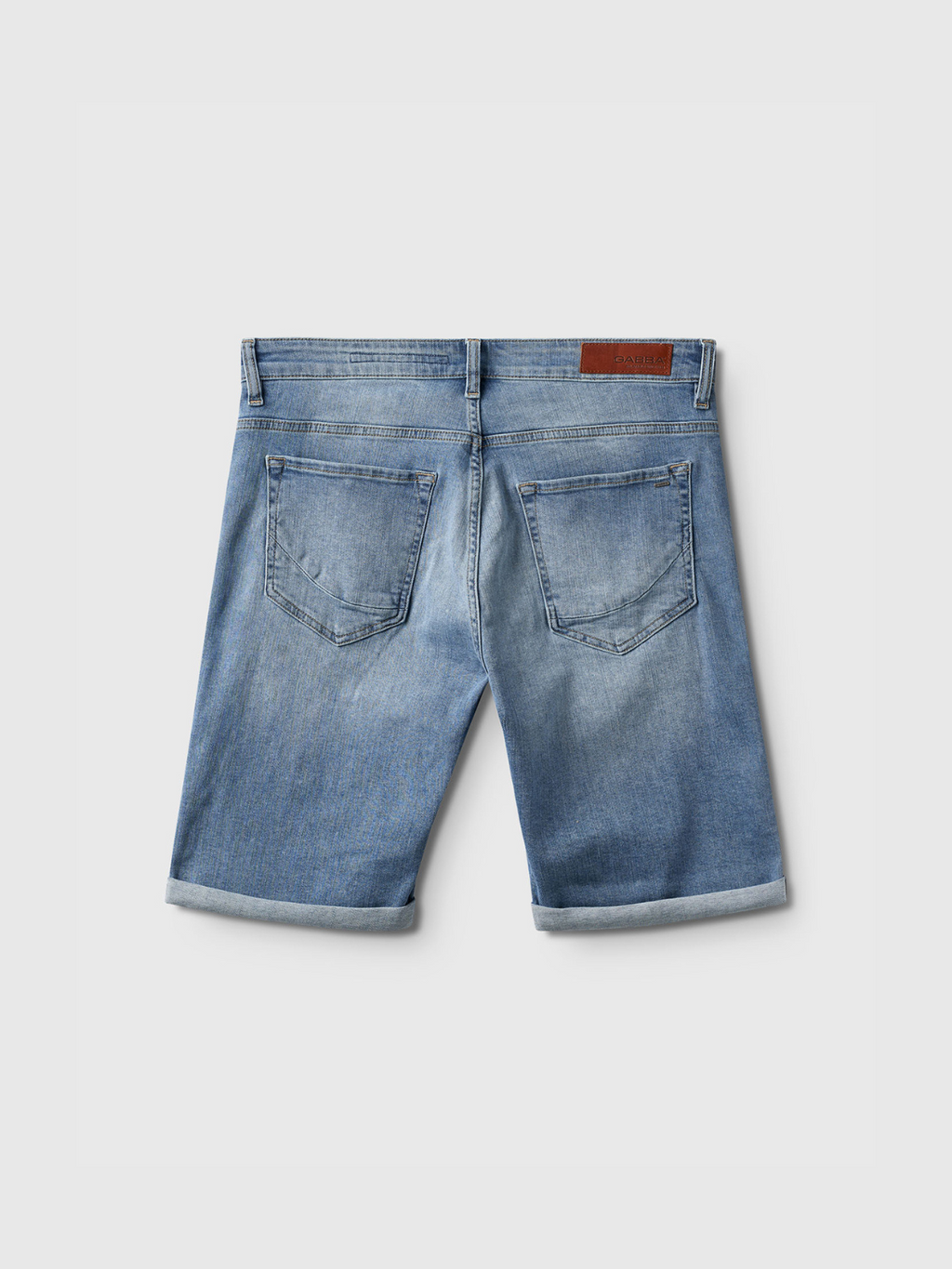 The Markus K4664 Shorts by Gabba in light blue denim are shown from the back with two back pockets, rolled cuffs, and a brown leather waistband patch, laid flat on a white background for a comfortable fit.