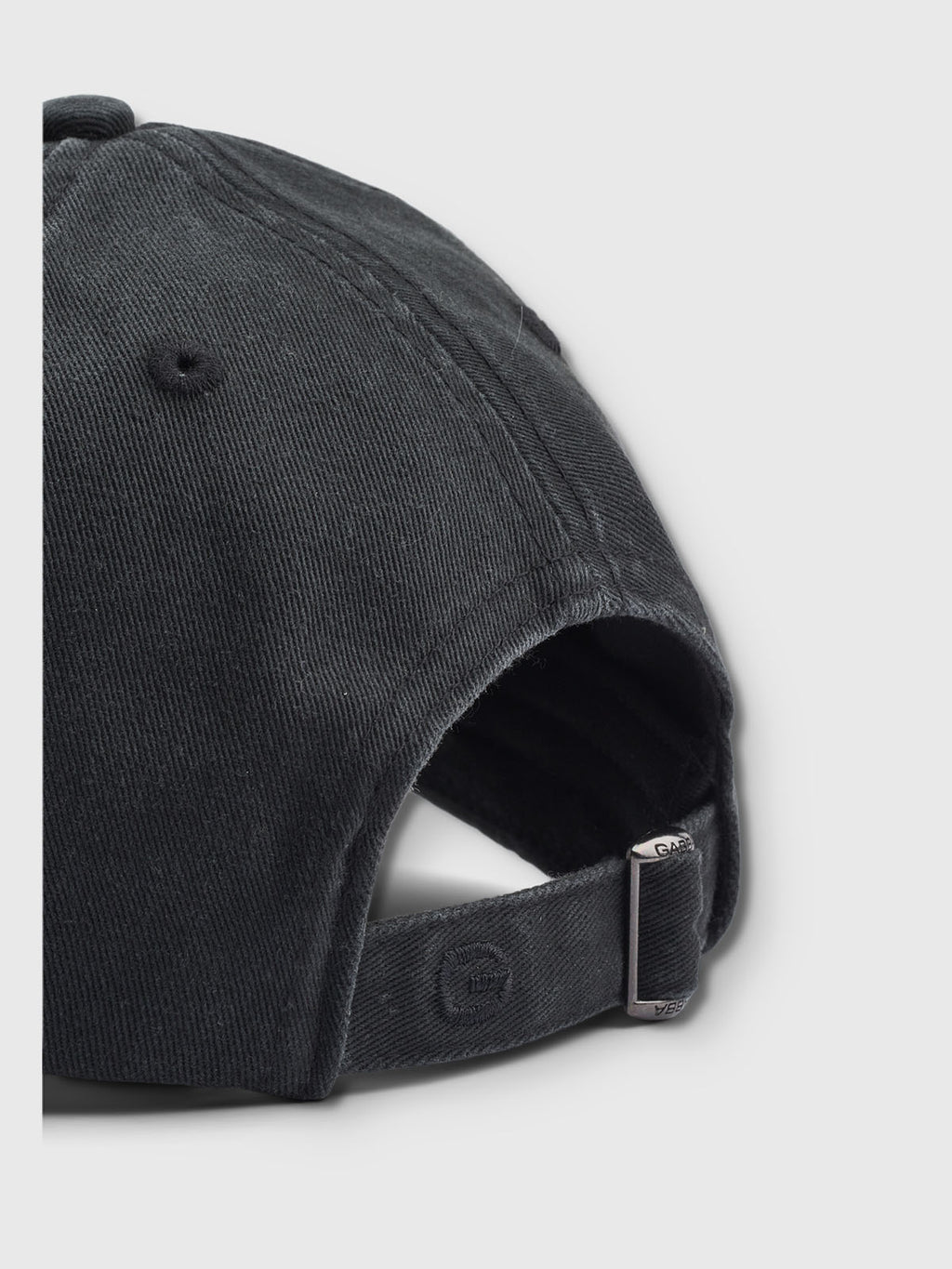 The Gabba Dad - Meteorite is a stylish black baseball cap made from cotton, showcasing an adjustable strap with a metal buckle. Set against a light gray background, this close-up highlights its textured fabric and meticulous stitching for enhanced comfort.