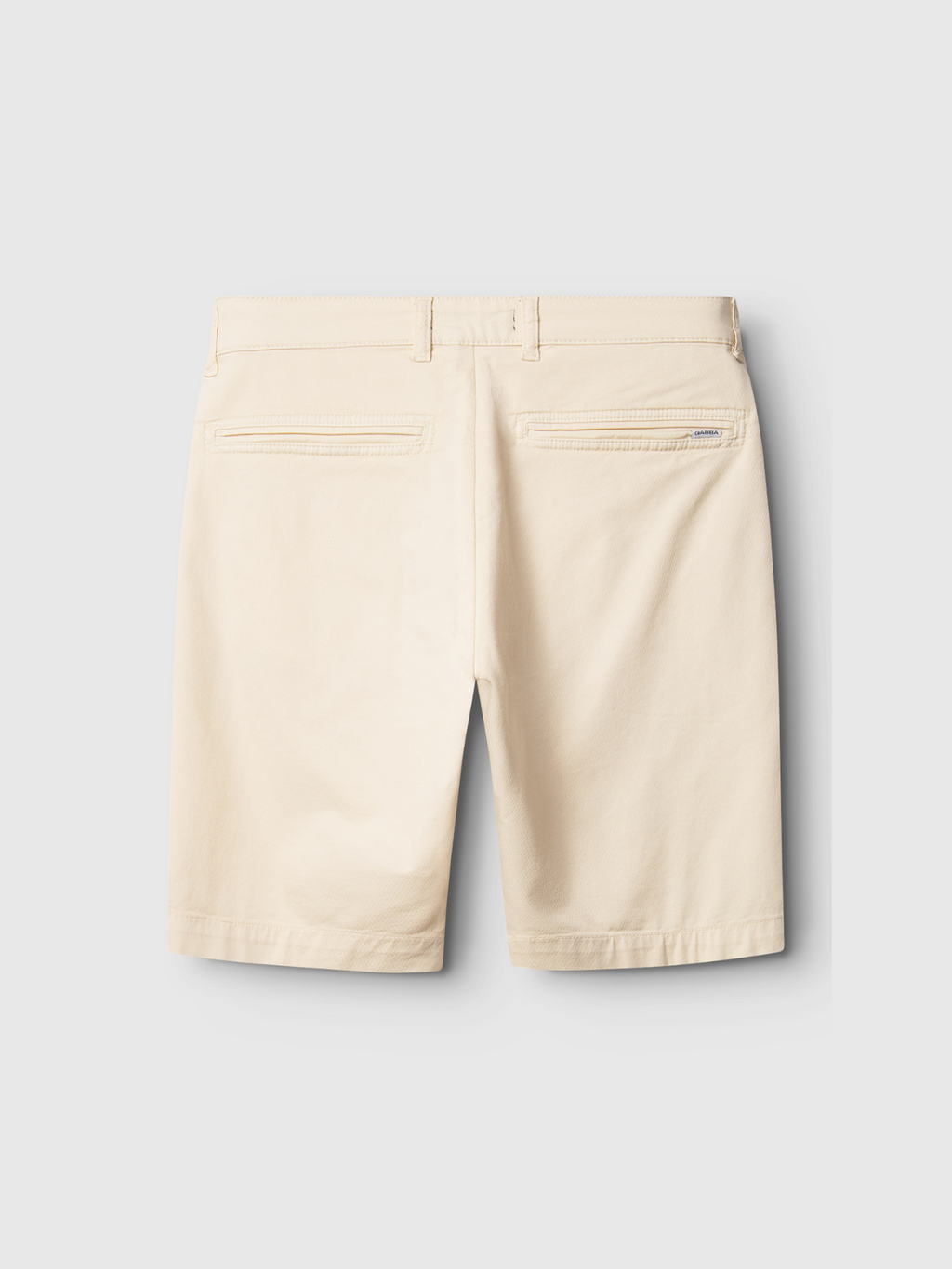 Back view of Gabba Jet K3280 Dale Shorts in Ecru Light, featuring belt loops, two back welt pockets, and a small brand tag above the right pocket, combining comfort and versatile style against a gray background.