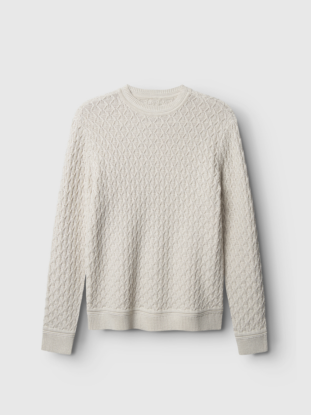 The Gabba Aksla Ls - Egret sweater, crafted in 100% cotton with a honeycomb knit pattern, is displayed against a light gray background. It features a round neckline, long sleeves, and ribbed cuffs and hem for superior comfort.