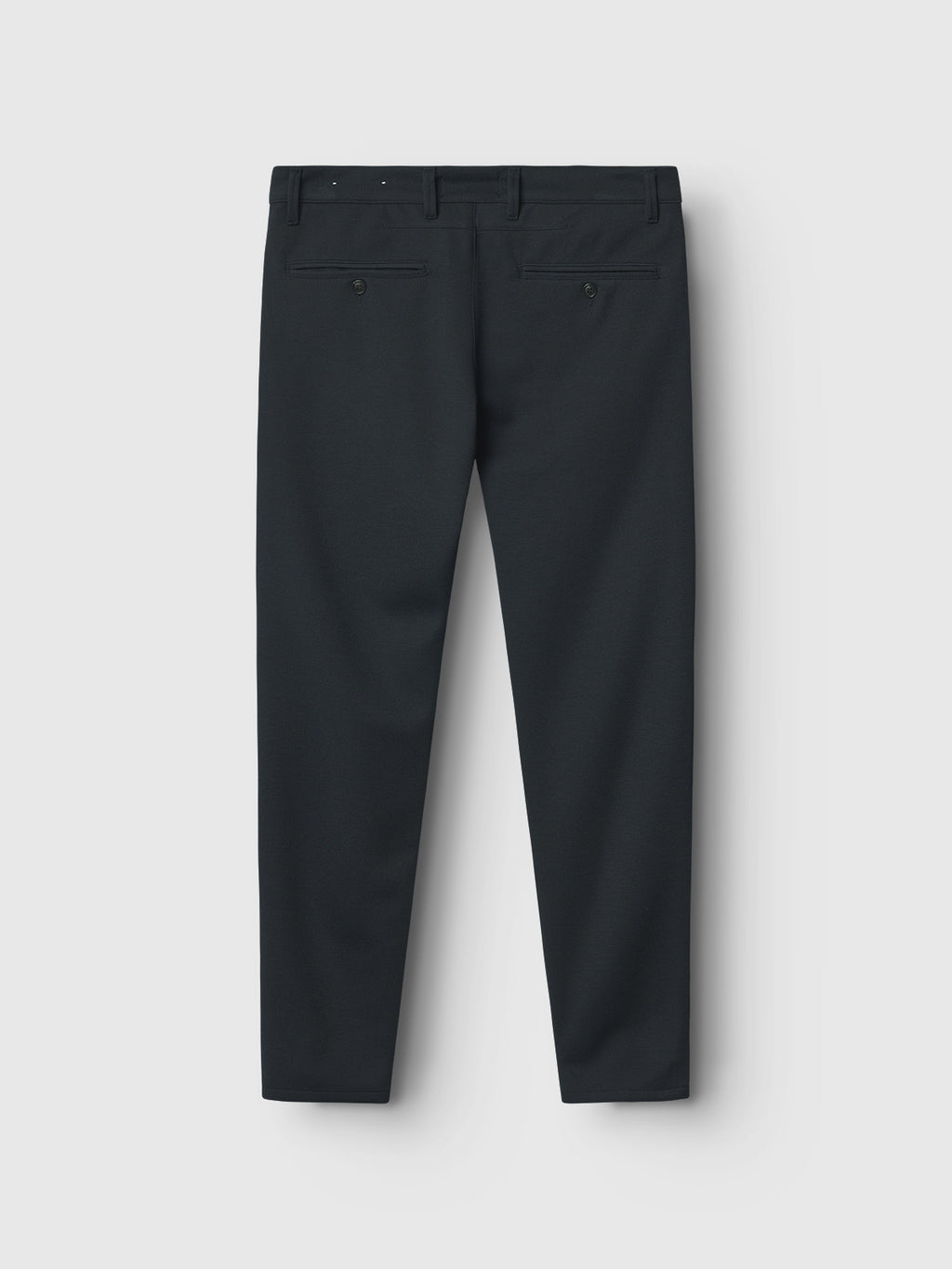 The image shows a pair of navy Paul Gknit pants by Gabba on a white background. Ideal for everyday wear, these slim-fit trousers feature two back buttoned pockets and a smooth, slightly shiny appearance due to the unique knitting technique.