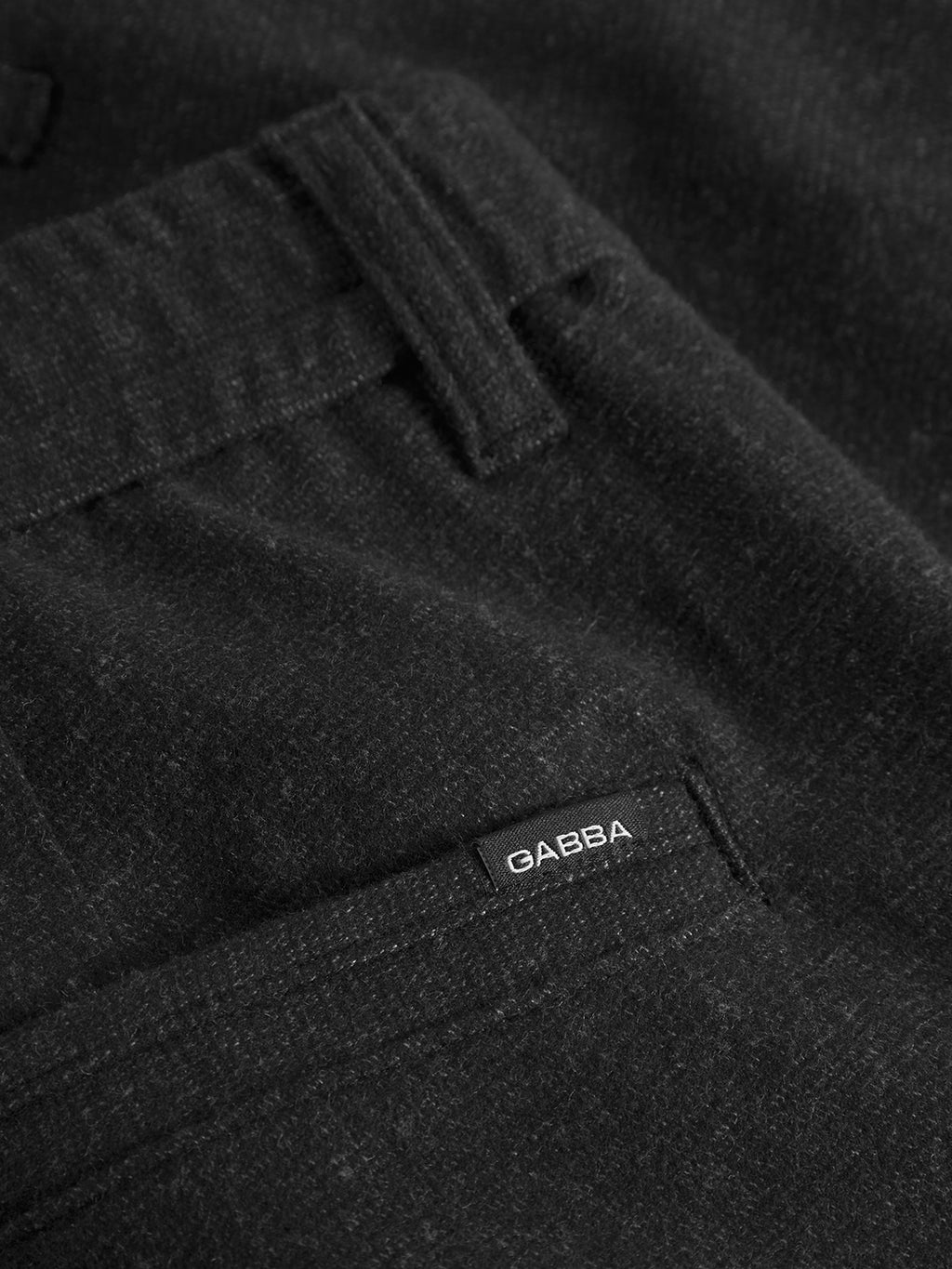 Close-up of the Monza Shafi - Black trousers by Gabba, featuring a visible belt loop and a small black Gabba tag near the pocket opening, showcasing modern detailing.