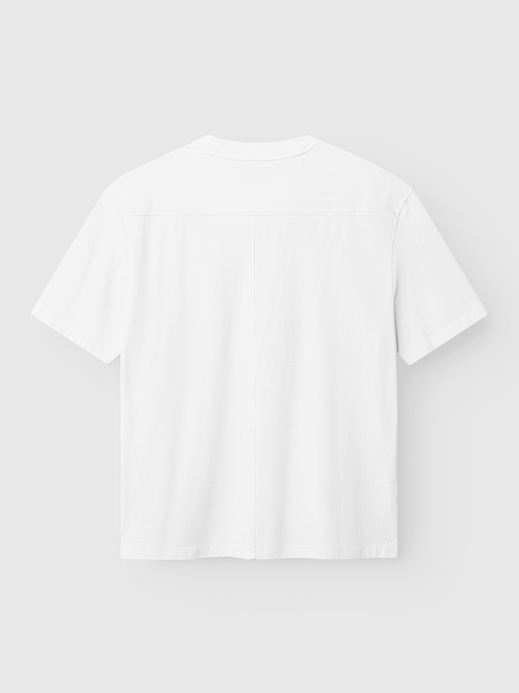 The Gabba Nigel Wix Boxy Hour SS - White, a vintage-inspired boxy-fit tee crafted from garment-dyed cotton, is shown from the back and laid flat against a light gray background.