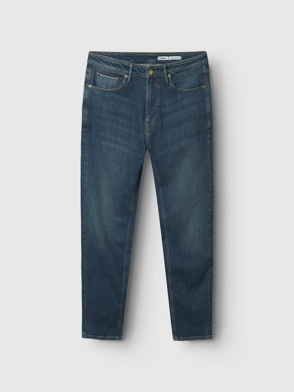 The Max Loom Dark Blue Denim jeans by Gabba are displayed flat, featuring a modern slim fit and classic five-pocket design with button and zipper closure. The lightly faded dark blue denim against a light gray background highlights their understated elegance.