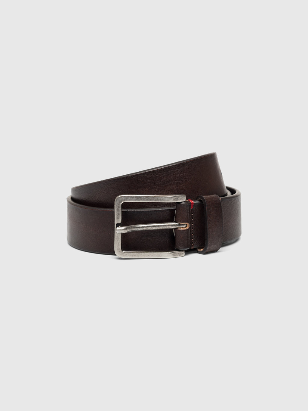 The Italy Belt - Brown by Gabba is crafted from high-quality dark brown leather, featuring a sleek silver rectangular buckle, and is elegantly showcased against a plain white background.
