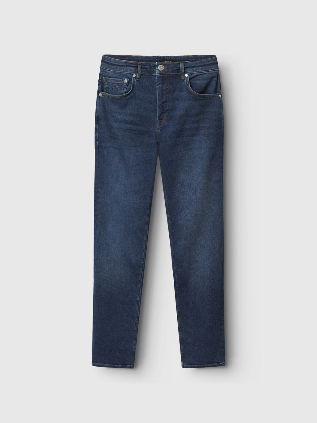 The Gabba Marc K4486 Limited jeans, in mid blue denim, feature a regular fit with a classic five-pocket design: two front pockets, a coin pocket, and two back pockets. Laid against a white background, these jeans provide a timeless yet modern look.
