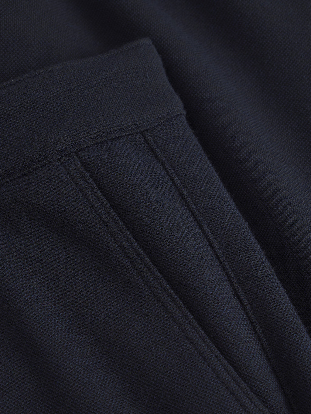 Close-up of the Venza GKnit - Navy by Gabba, highlighting a seam pocket and textured material with focus on the stitching and soft woven texture, enhancing its classic appeal.