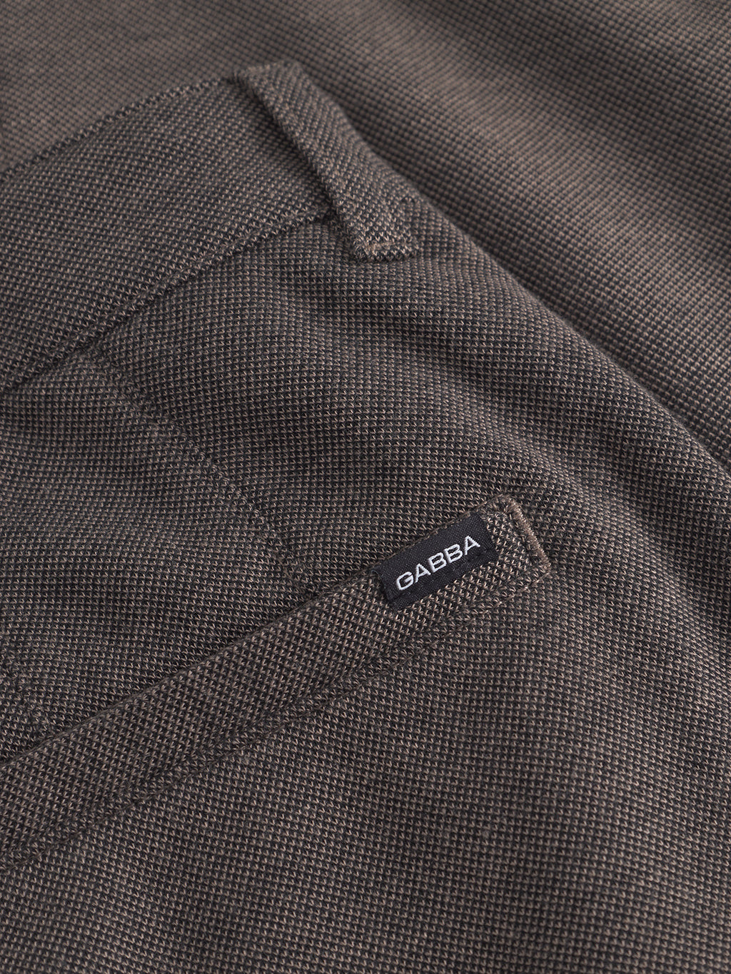 Close-up of the Venza GKnit - Sand by Gabba, featuring the classic design with textured fabric, highlighting the back pocket and a black Gabba label.