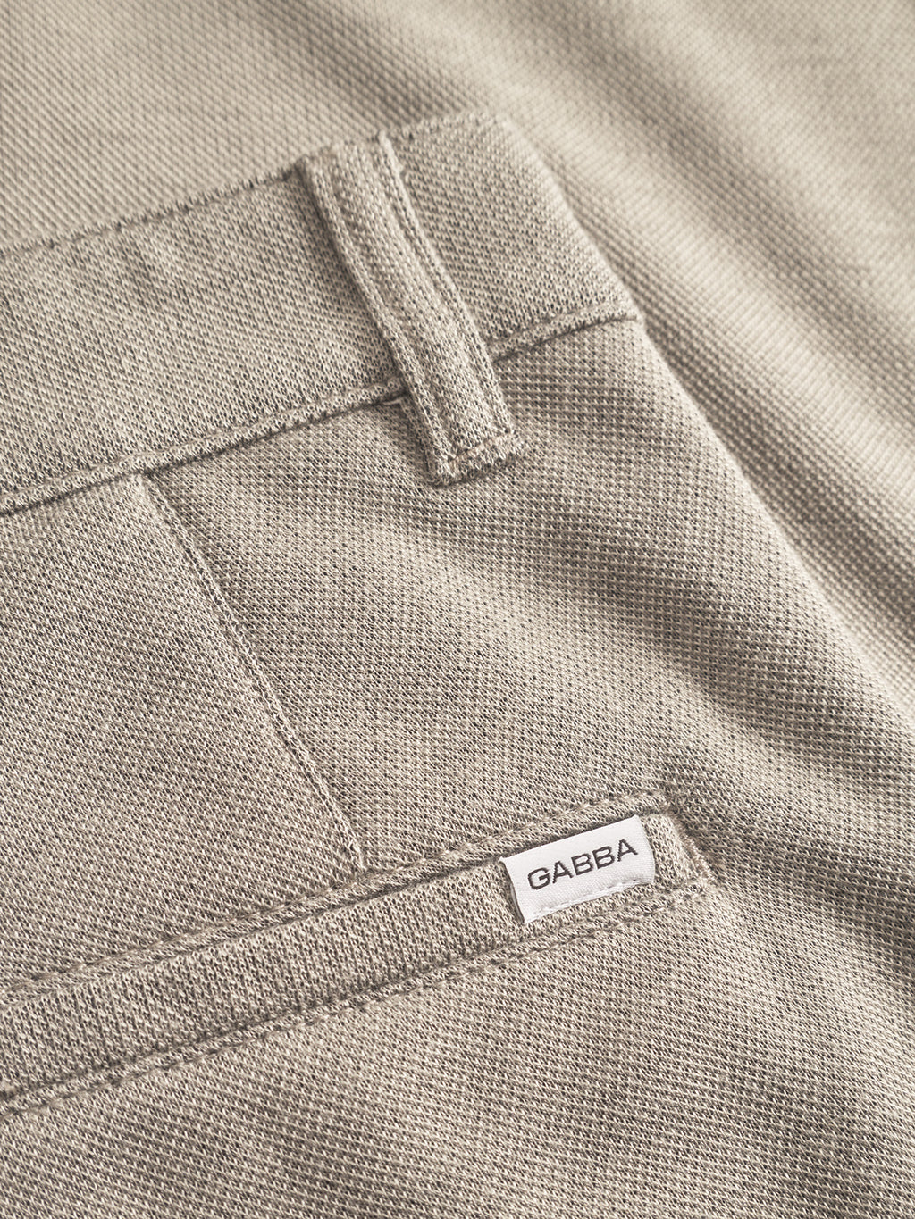 Close-up of light green textured Gabba Venza GKnit trousers with a back pocket. A small white label on the right side displays GABBA, crafted with innovative structure fabric.