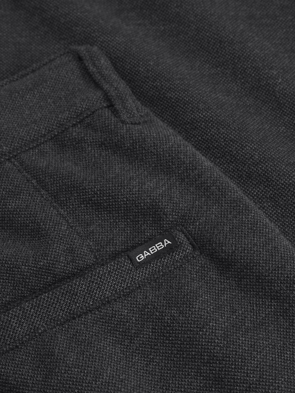Close-up of the back pocket of Gabbas Venza GKnit - Dk. Grey pants, highlighting the innovative structured fabric with a small GABBA label stitched near the pocket opening.