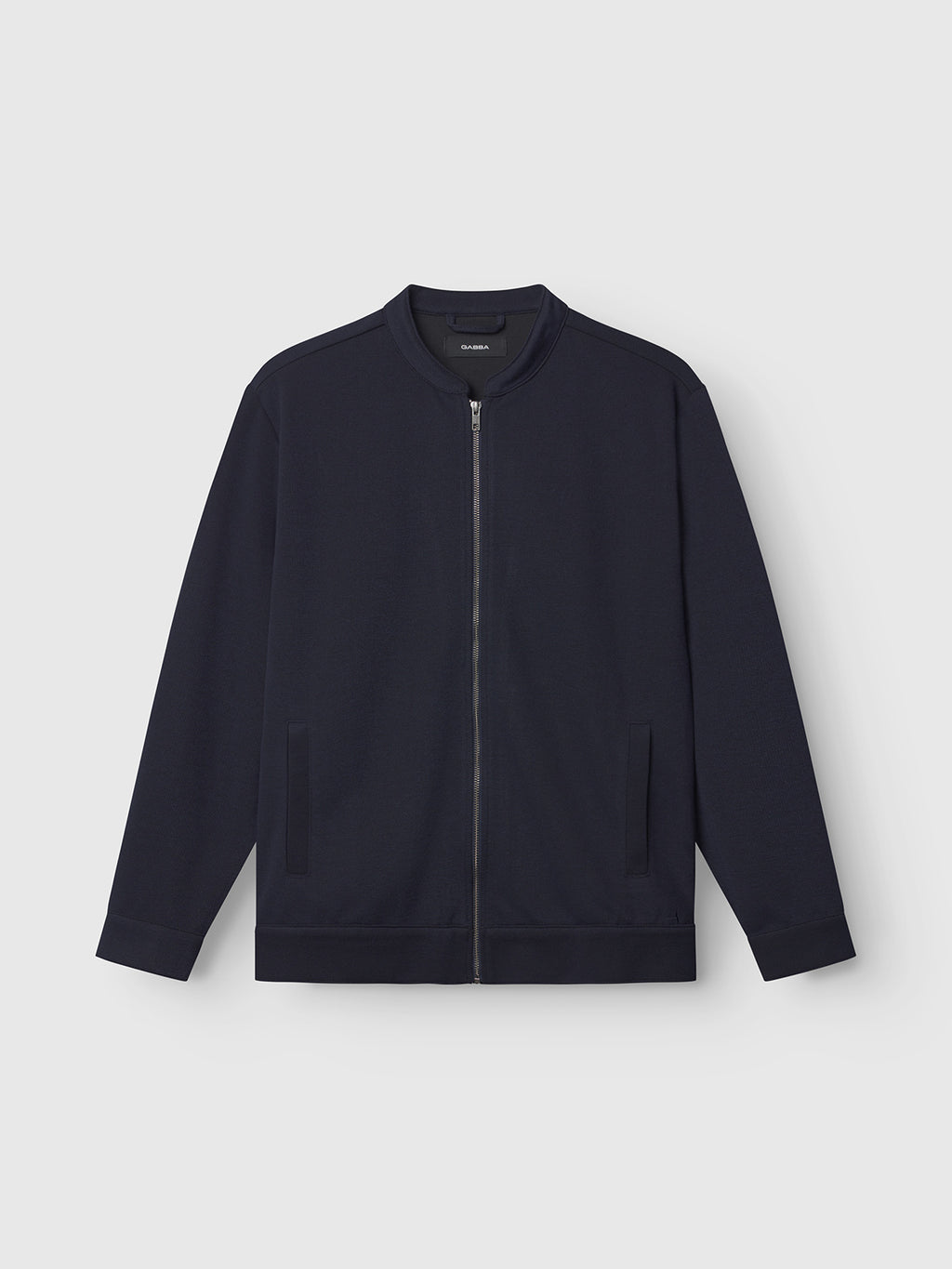 The Gabba Toto Gknit in navy is a sleek zip-up jacket with a minimalist design made from a viscose mix. It features a collarless neckline and two front pockets for an everyday look, set against a light gray background.