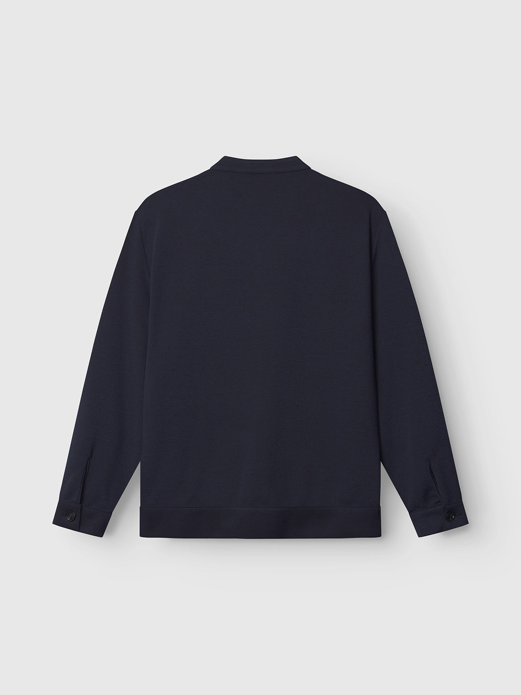 The Toto Gknit - Navy by Gabba is a navy blue long-sleeve shirt with a collar, made from viscose mix fabric, featuring buttoned cuffs and a straight hem. Displayed from the back against a plain light gray background, it’s ideal for an everyday look.
