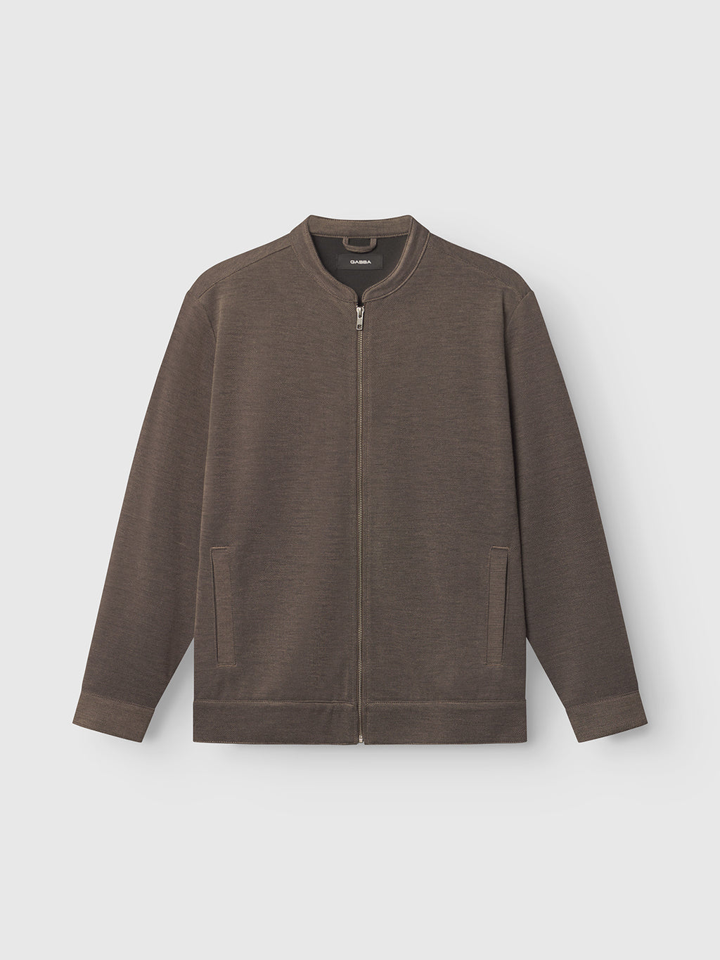 The Toto Gknit - Sand by Gabba is a collarless brown zip-up jacket made from a viscose mix, showcased against a white background. It features ribbed cuffs and hem, plus two front pockets, perfect for casual wear.
