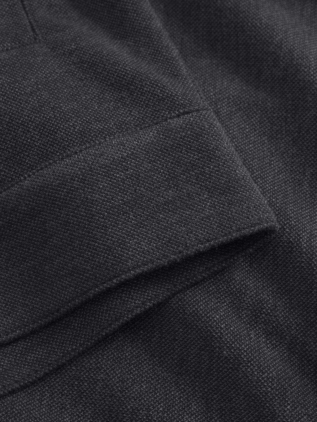 Close-up of a folded sleeve on the Gabba Toto Gknit - Dk. Grey, highlighting its textured soft viscose mix fabric with fine weaving and stitching details.