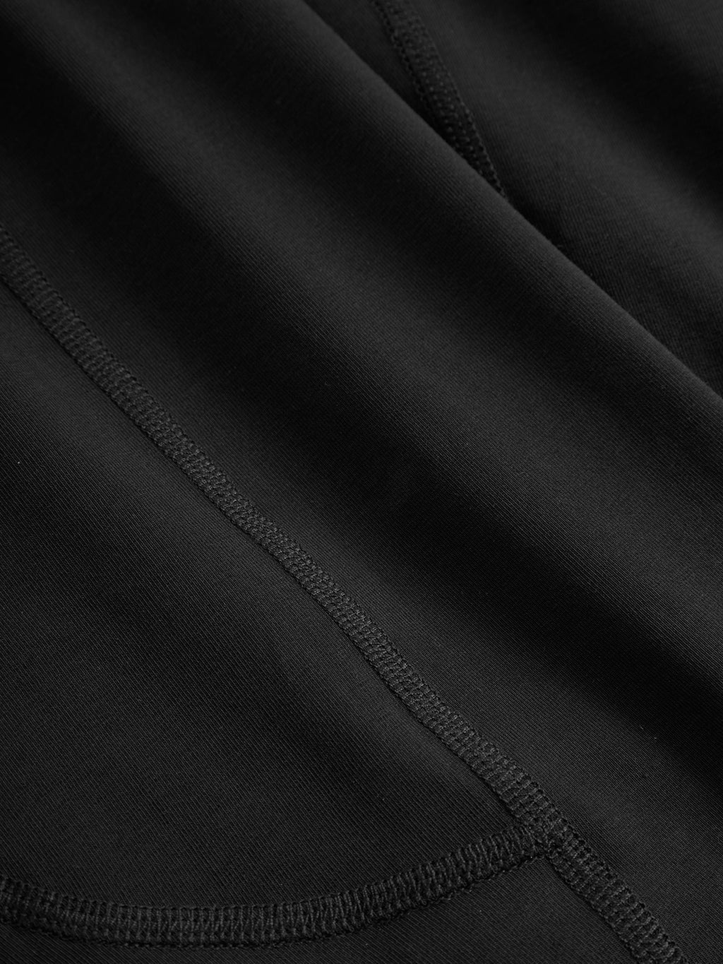 Close-up of black fabric with visible stitching and the discreet Gabba logo. The material is smooth with neatly sewn intersecting lines, reminiscent of Trunk News soft, durable textile and elastic waistband.