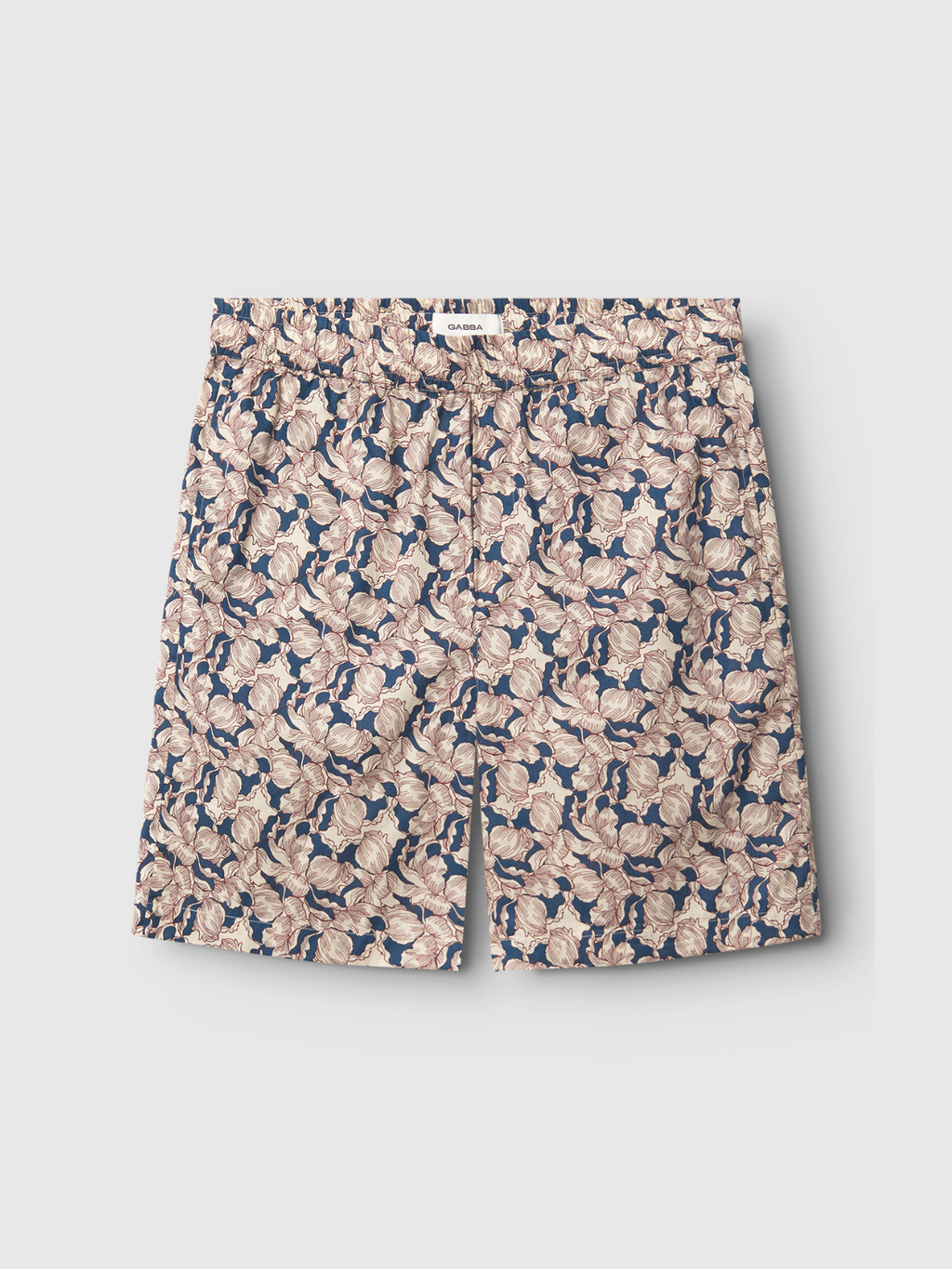 Gabbas Porter Epo - Blue Pattern shorts feature a summer-inspired floral design in beige, cream, and pink with green leaves on navy blue 100% cotton, displayed flat on a light gray surface.