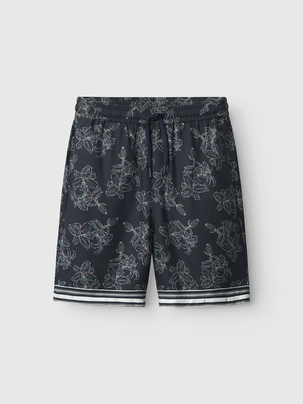 The Porter Lofi - Flower Mix shorts by Gabba feature a navy blue base with a white floral print, elastic drawstring waistband, striped hem trim, and practical pockets. Stylishly displayed against a light gray background.
