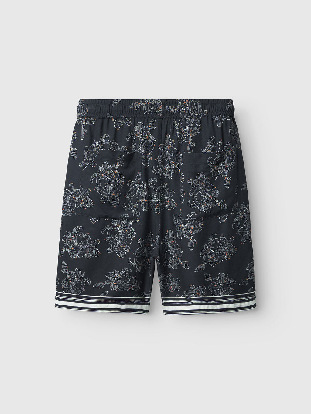 The Gabba Porter Lofi - Flower Mix shorts feature a dark base with a white floral print, elastic waistband, and white-striped hem accents, shown against a plain light background.