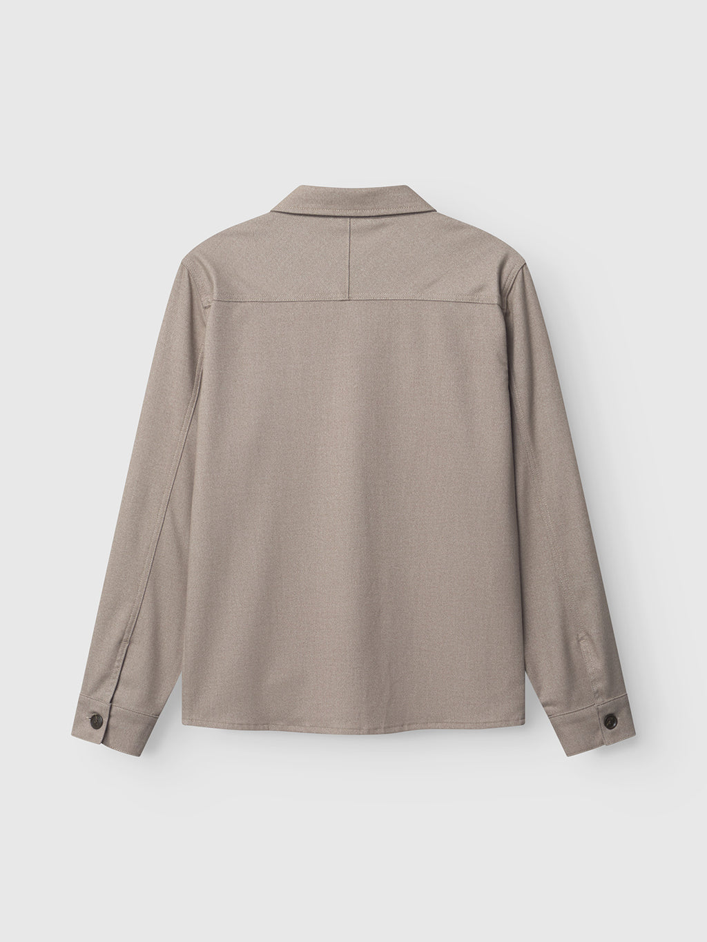 A rear view of the Gabba Clipper Shafi in brown is shown against a white backdrop. This long-sleeve shirt sports a classic collar and buttoned cuffs, with refined stitching accentuating its straight hem and sophisticated wool-like appearance.