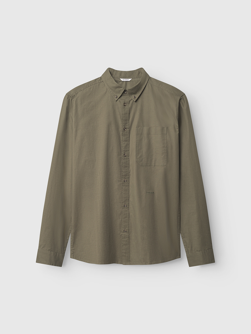 The Bent Reg Ox LS by Gabba is a versatile long-sleeved, army green button-up shirt made from stretch cotton, featuring a left chest pocket. Its displayed against a plain white background.