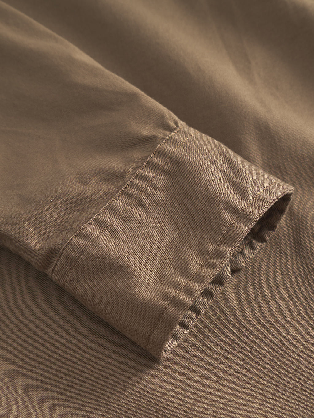 Close-up of the cuff on Gabbas Bent Reg Ox LS - Brown highlights fabric texture and stitching detail. This versatile design combines formal and casual styles with soft, slightly wrinkled material.