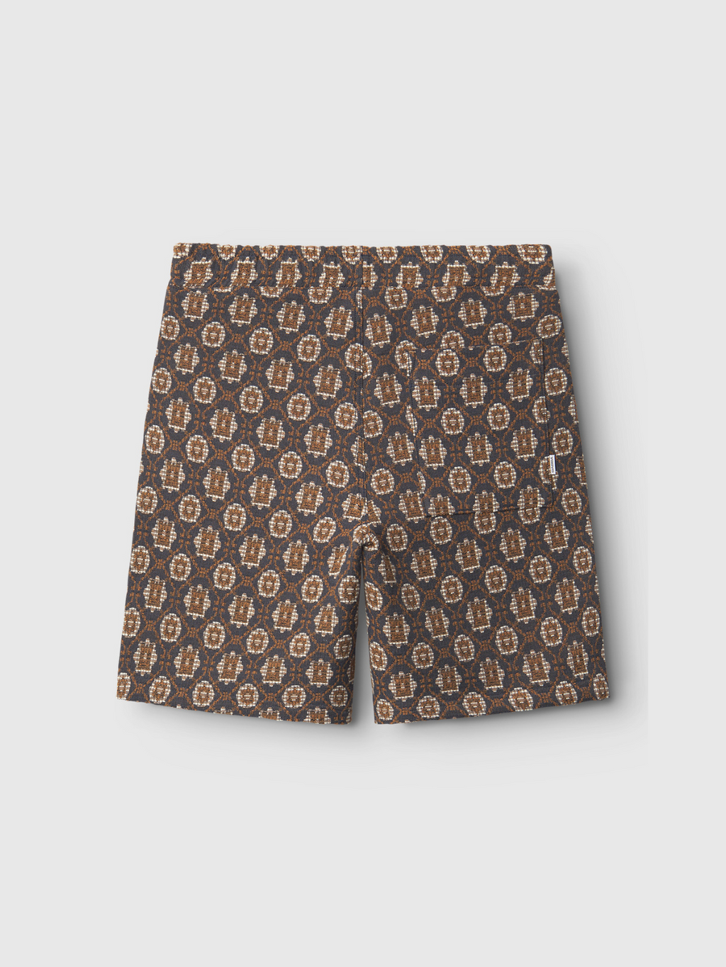 The Gabba Fede Box Star - Multi Pattern shorts feature an elastic waistband and a tan-beige geometric floral print, offering a relaxed style. Displayed from the back on a plain white background.