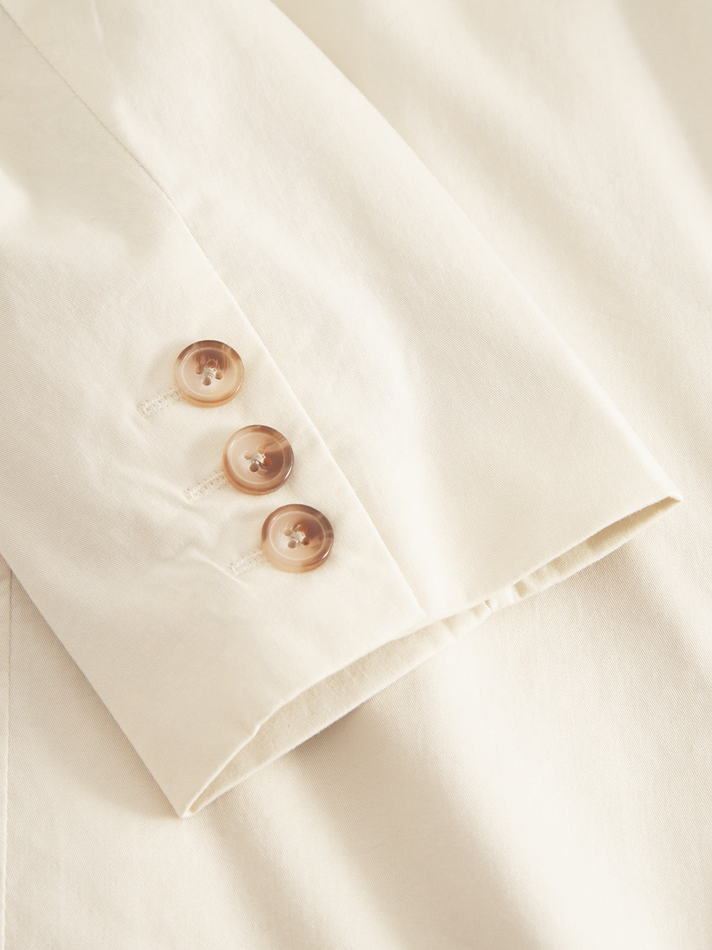 Close-up of the Josh Unite - Beige blazer by Gabba shows a premium sleeve with three brown buttons. The cotton stretch fabric is smooth and slightly textured, featuring clean edge stitching for a stylish regular fit.