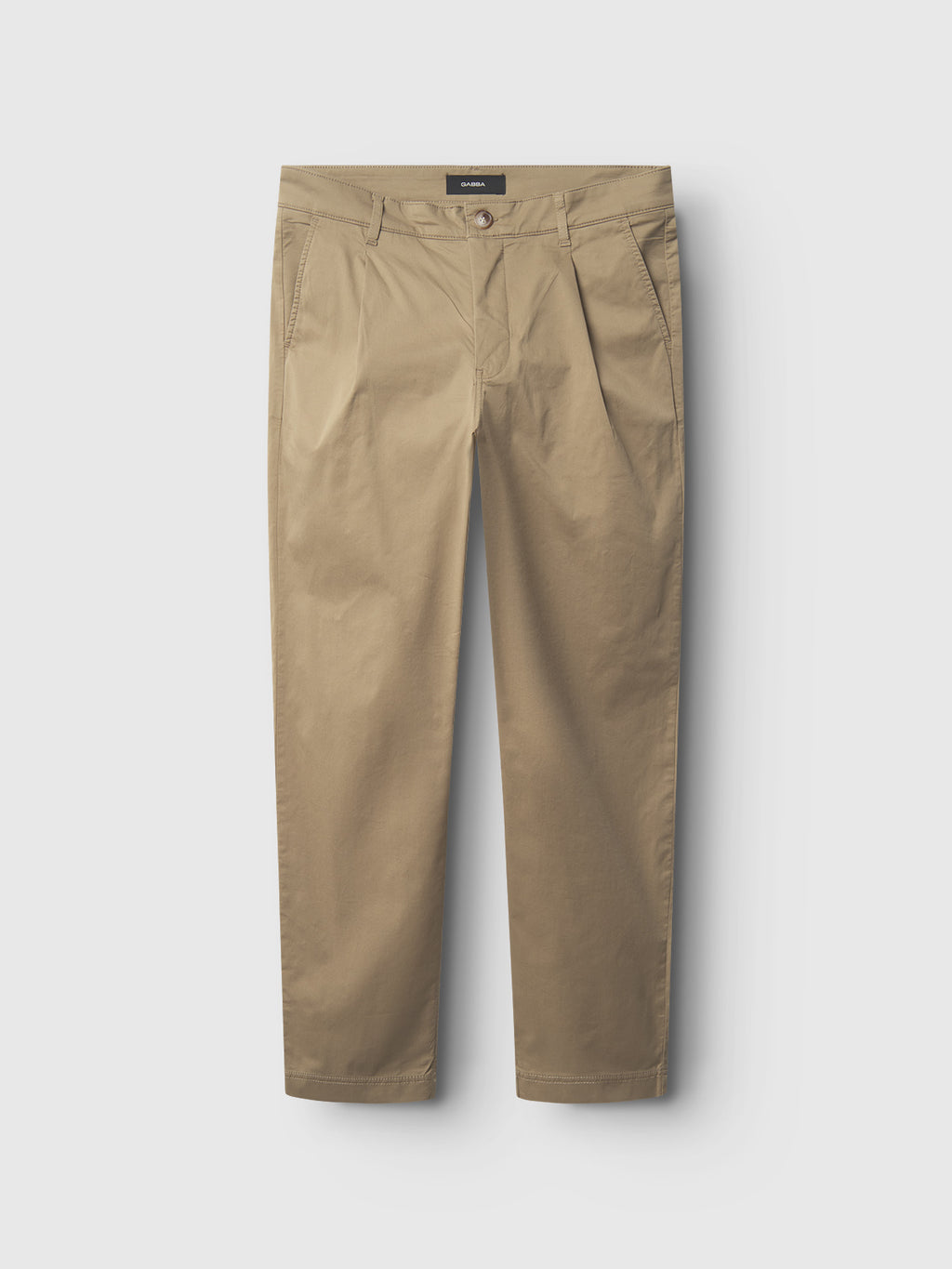The Gabba Joe Unite chinos in Sand feature a relaxed fit with button and zip closure, side pockets, and belt loops. Their straight-leg design on a white background ensures a comfortable, casual look perfect for any occasion.
