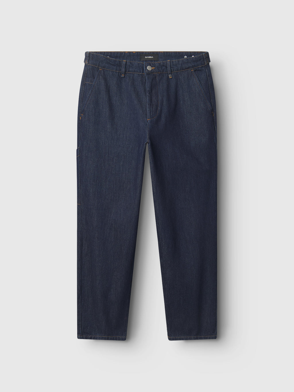 The Vito dark blue denim jeans by Gabba are showcased on a white background, highlighting their classic five-pocket design with belt loops and button closure. They feature workwear-inspired details like tabac stitching for a distinctive look.