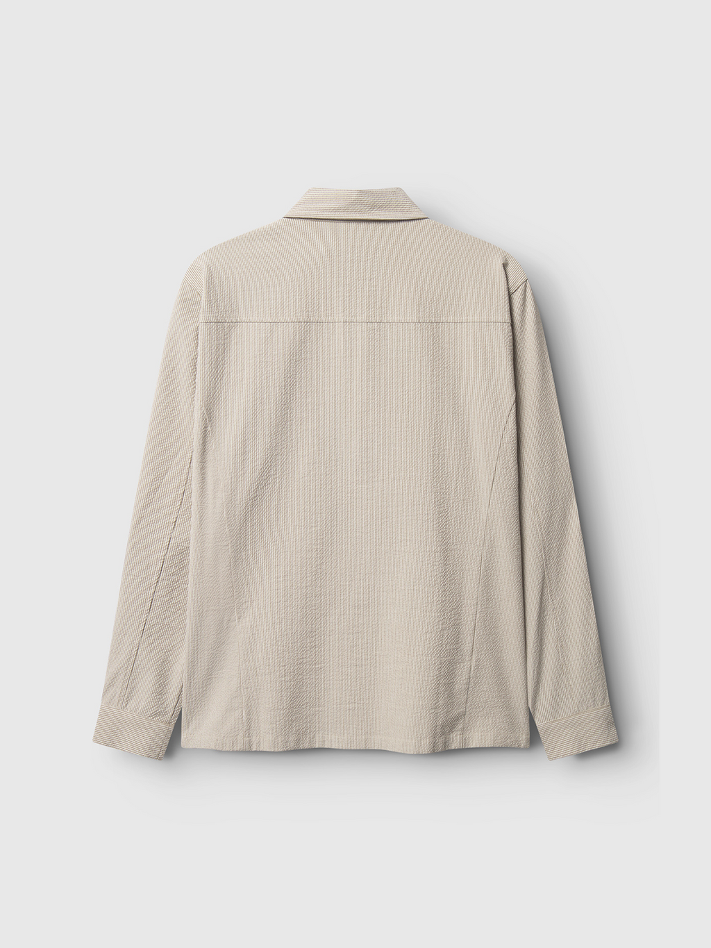 The Gabba Today Com2 shirt in khaki is a light beige, long-sleeve seersucker piece shown from the back, with a flat collar, straight shoulder yoke, and relaxed fit for a sophisticated look against a plain white background.