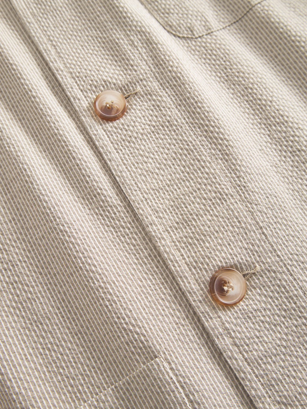 Close-up of Gabbas Today Com2 - Khaki featuring beige and white striped fabric, two large cream buttons, and a waffle texture that creates a subtle grid effect around the buttons, evoking premium blazer vibes.