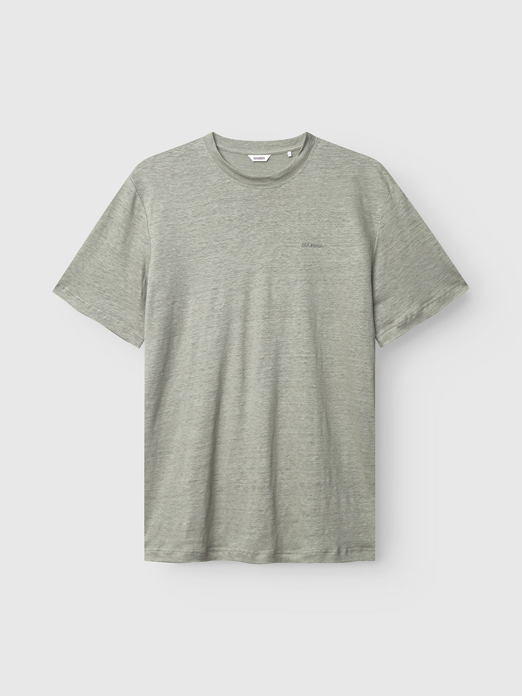 The Gabba Duke Linen Logo SS in light green is showcased against a plain background. This short-sleeve t-shirt has a simple design with a round neckline, tone-on-tone stitching, and small logo embroidery on the left chest.