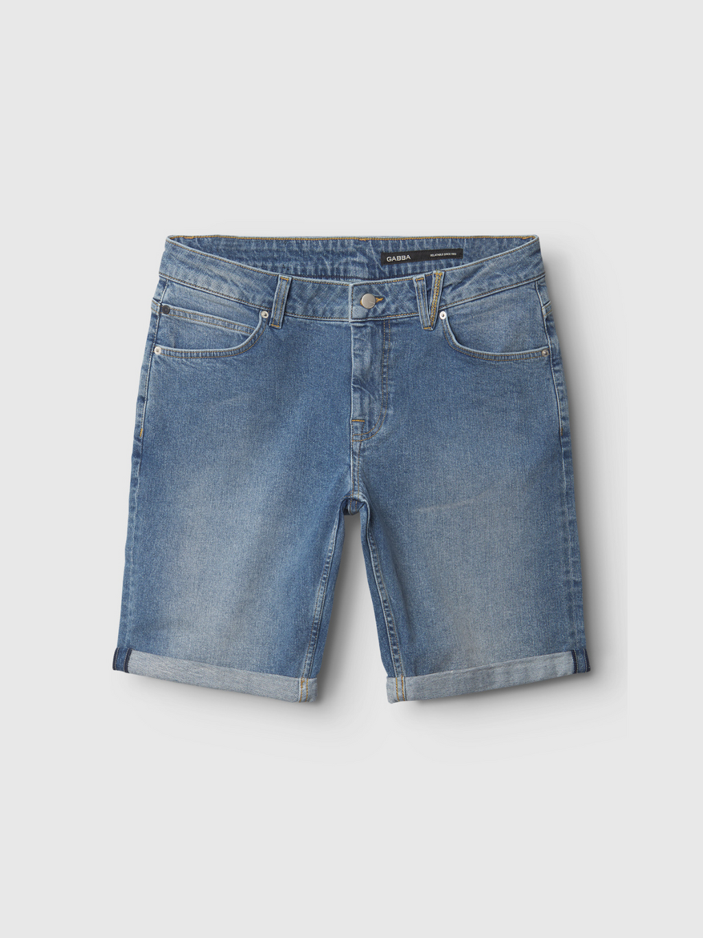 The Markus 5poc - Mid Blue Denim shorts by Gabba feature a rolled-up hem, five pockets, belt loops, and a button closure. Laid flat on a light gray background, they blend classic style with everyday comfort.