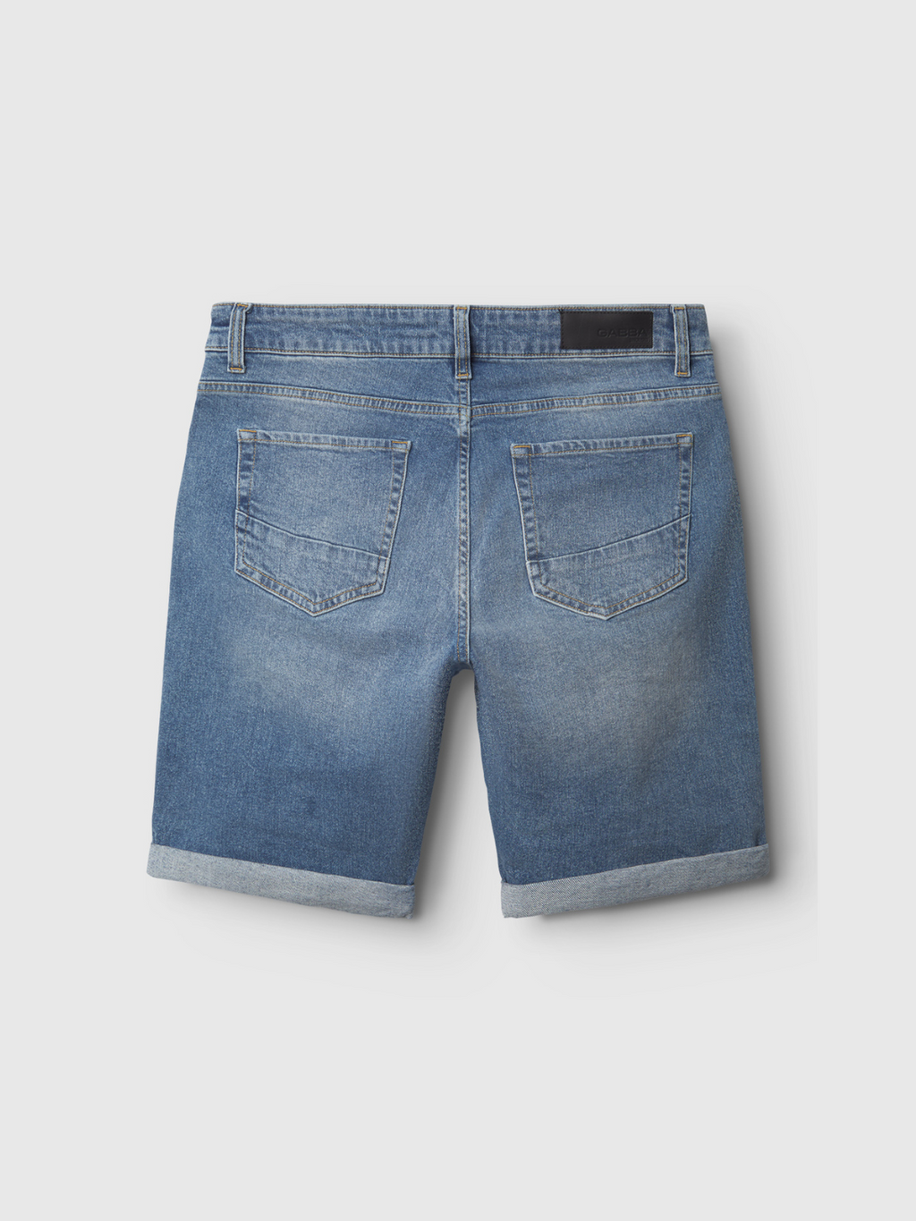 Back view of Gabba Markus 5poc Mid Blue Denim shorts featuring rolled hems, two back pockets, belt loops, and a black waistband patch, designed for comfort and shown on a plain light background.