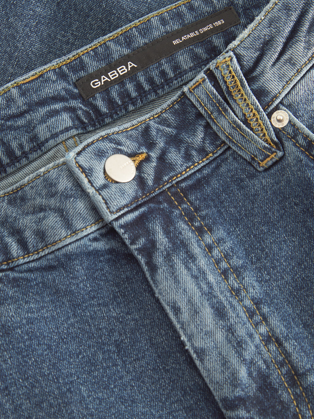 A close-up of Markus 5poc - Dark Blue Denim jeans showcases a metallic button and black Gabba label with Reliable Since 1983. The jeans feature contrast stitching, belt loops, and offer a comfortable fit for any occasion.