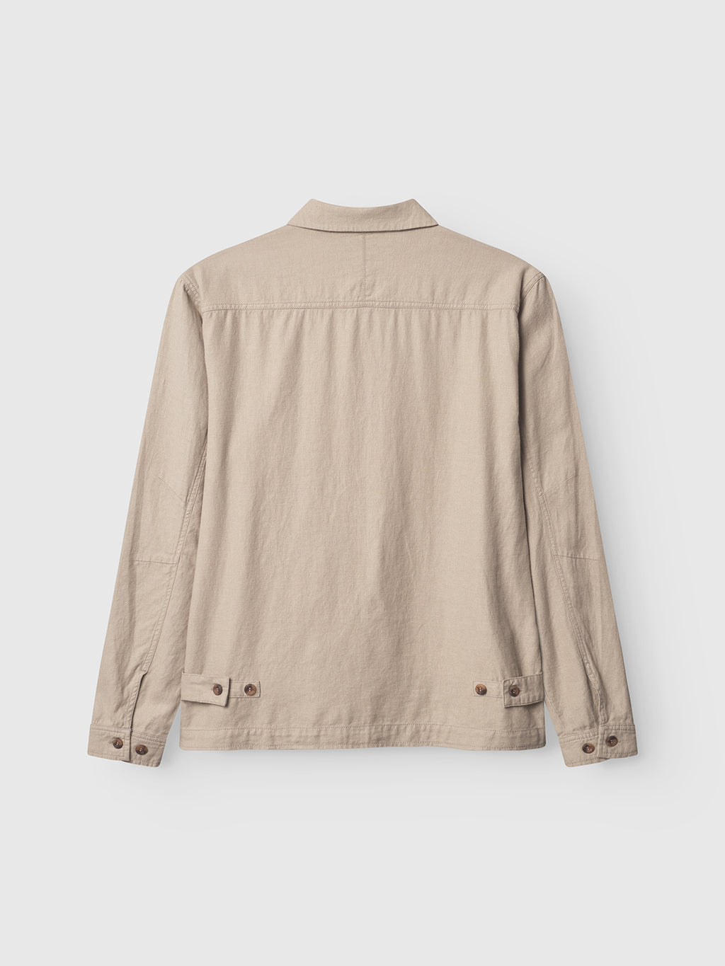 The Gabba Peter Lino - Sand Plaza is a beige long-sleeved overshirt showcased from the back on a white background. Ideal for spring, it includes buttoned cuffs, an adjustable buttoned waistband, and is crafted from a cozy linen/cotton blend.