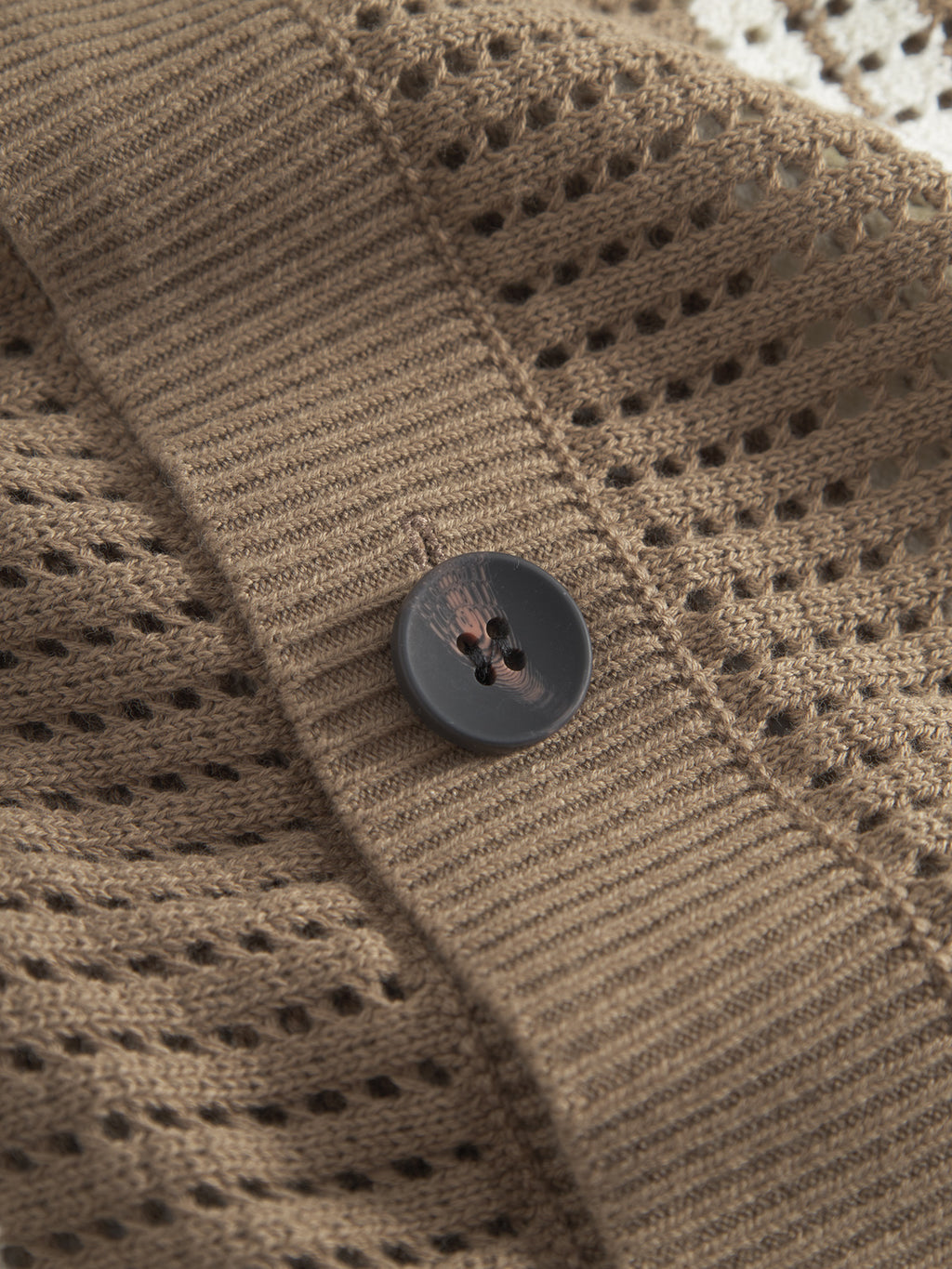 Close-up of Gabbas Dezz Stripes LS - Brown Stripe, showcasing a textured cotton knit with solid and mesh-like vertical stripes and a round, dark brown button.