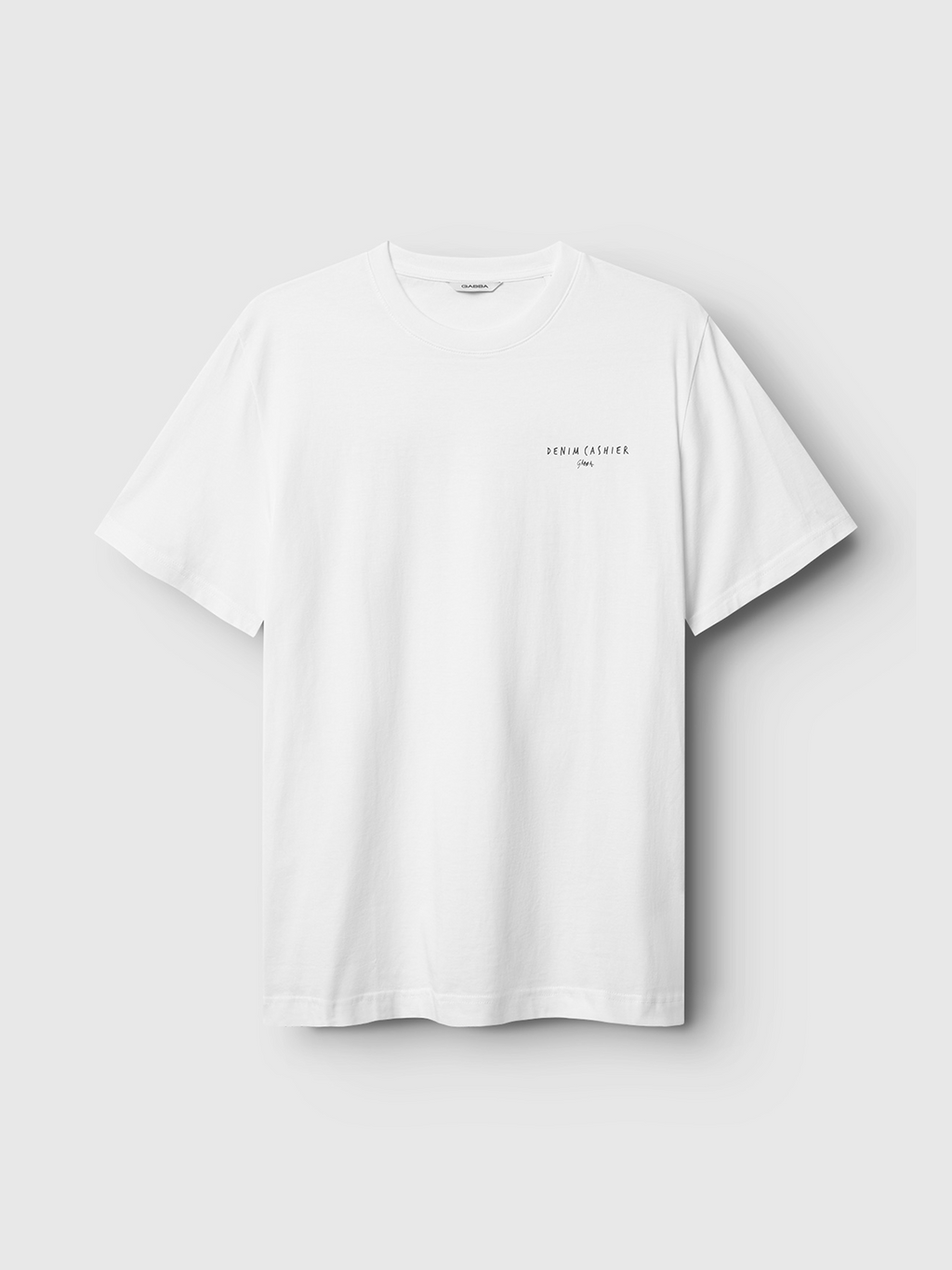The Gabba Dune Kiosk A SS GOTS - White is a premium organic cotton t-shirt, plain white with subtle black SEREN CALDERA text on the left chest, shown on a light gray background.