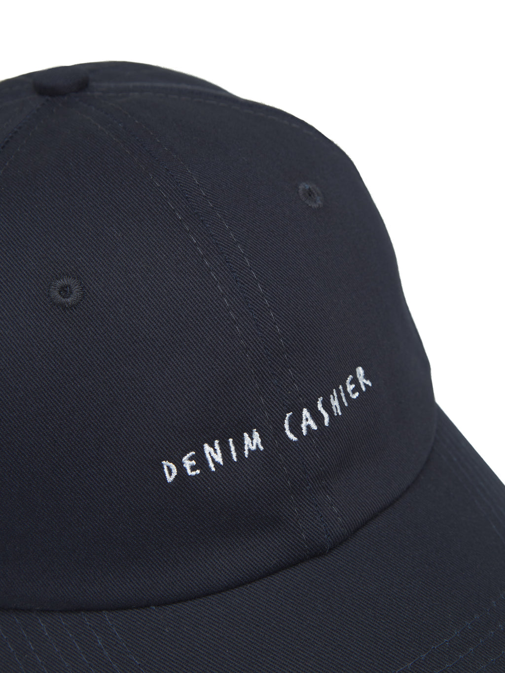 Close-up of the Gabba Cashier Cap - Night Sky in 100% cotton, featuring DENIM CASHIER embroidered in white on the black front panel, along with a top button and stitched ventilation eyelets.