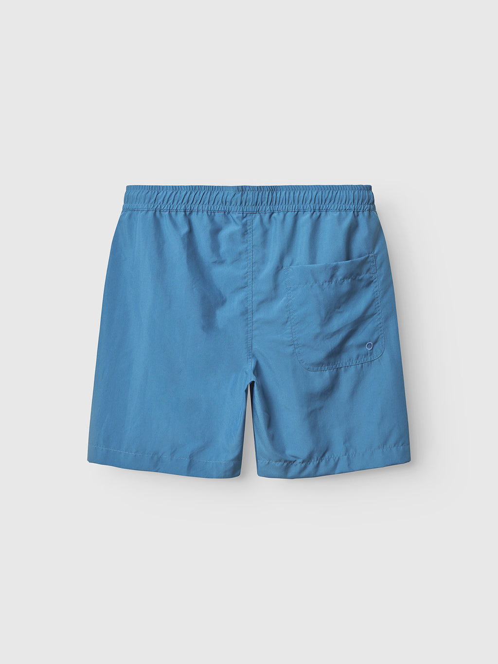 The Gabba Jackson Plain - Blue Horizon swim shorts feature an elastic waistband, side pockets, and a back pocket, shown flat on a light gray background.