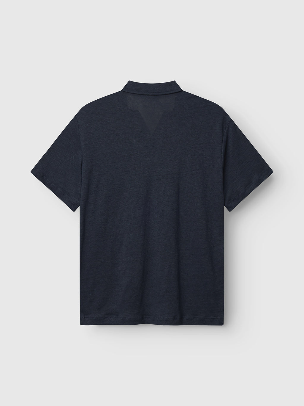 Gabbas Trevor - Navy is a plain short-sleeve polo shirt, crafted for comfort. Laid flat against a white background, it highlights its simple design and texture.