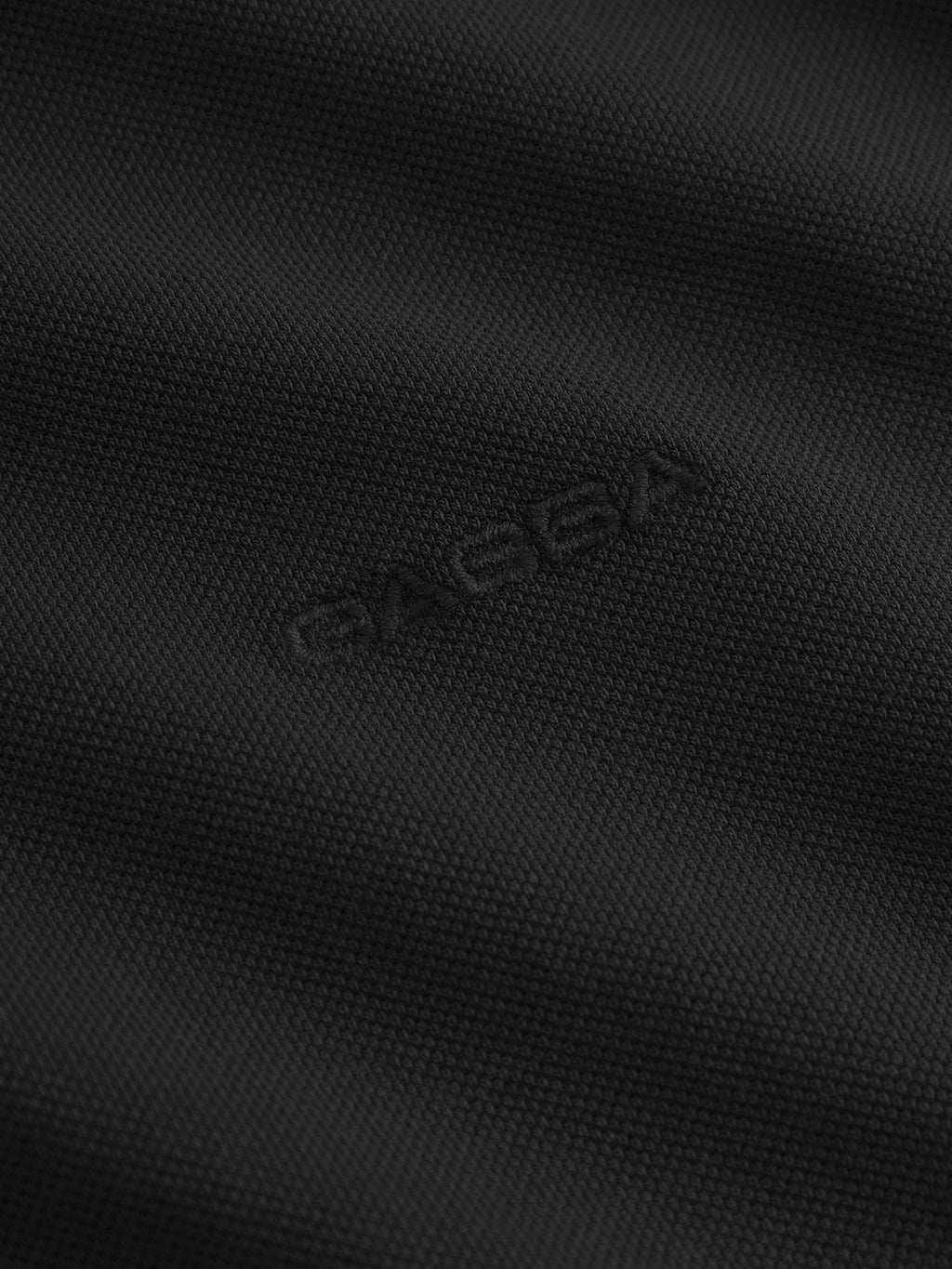 Experience ultimate comfort and style with the Neo Pique Resort SS - Meteorite by Gabba. This textured black fabric features a fine weave, matte finish, and subtle raised BASSA logo embossed for an effortlessly enhanced personal style.