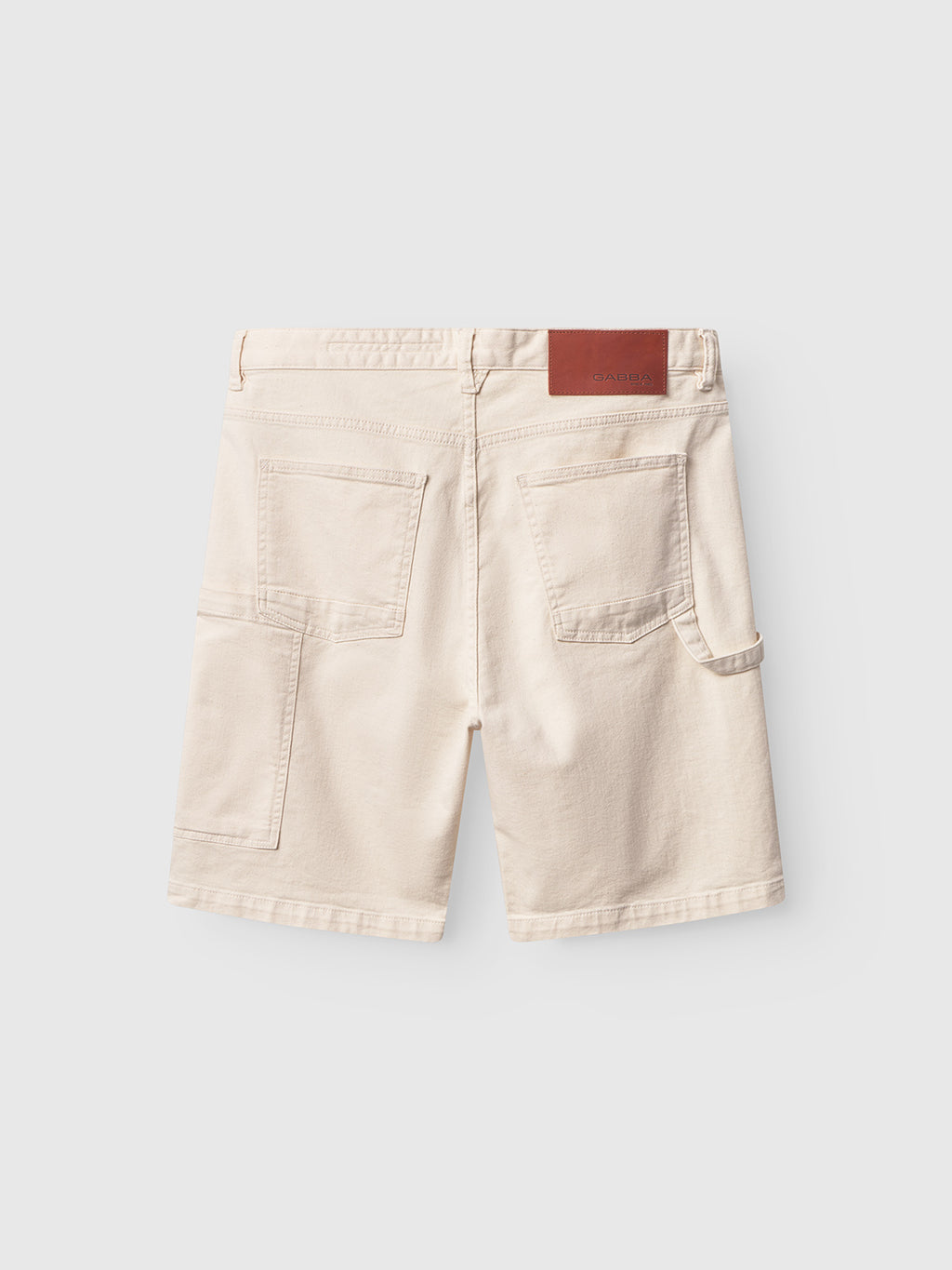 The back view of Gabbas Ecru Maxwell Luis Cargo Shorts on a plain background shows their classic workwear style with two large back pockets, a side loop, and a brown leather patch on the waistband. These utility shorts are made from non-stretch fabric.